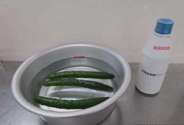 写真：野菜をボールに入れた次亜塩素酸ナトリウム溶液にひたしている